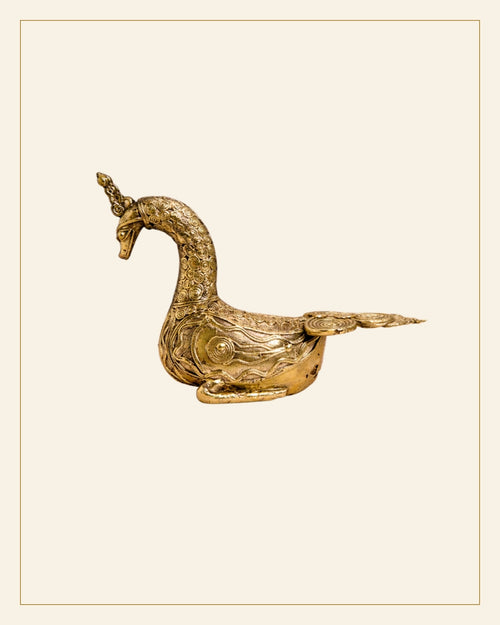 Handcrafted Brass Sitting Peacock Sculpture – Traditional Bhareva Bell Metal Artefact — Saptadhārā