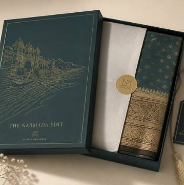 Saptadhārā Narmada Edit packaging — river box with gold foil, ivory tissue and wax seal