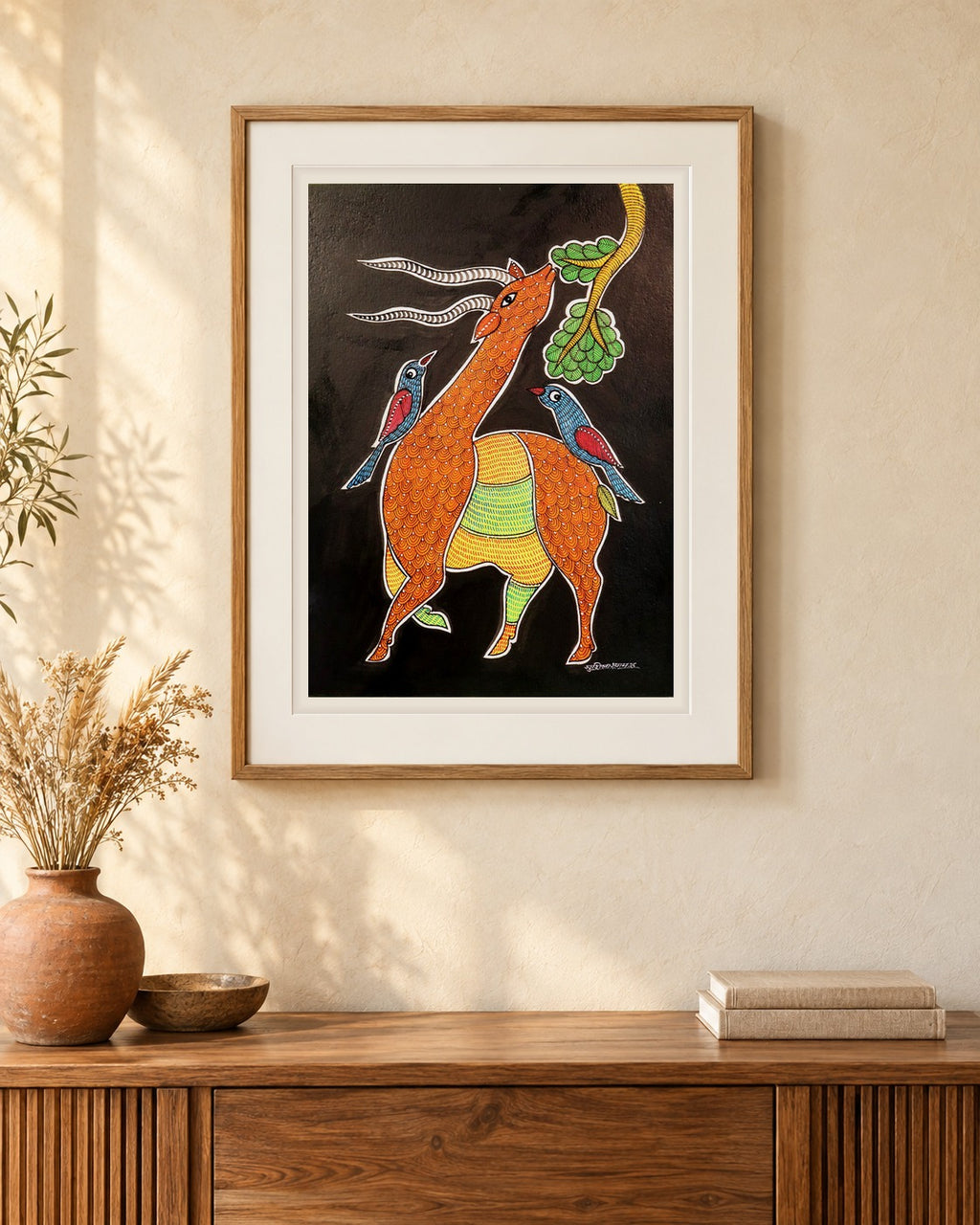 Original Gond painting shown framed on a wall