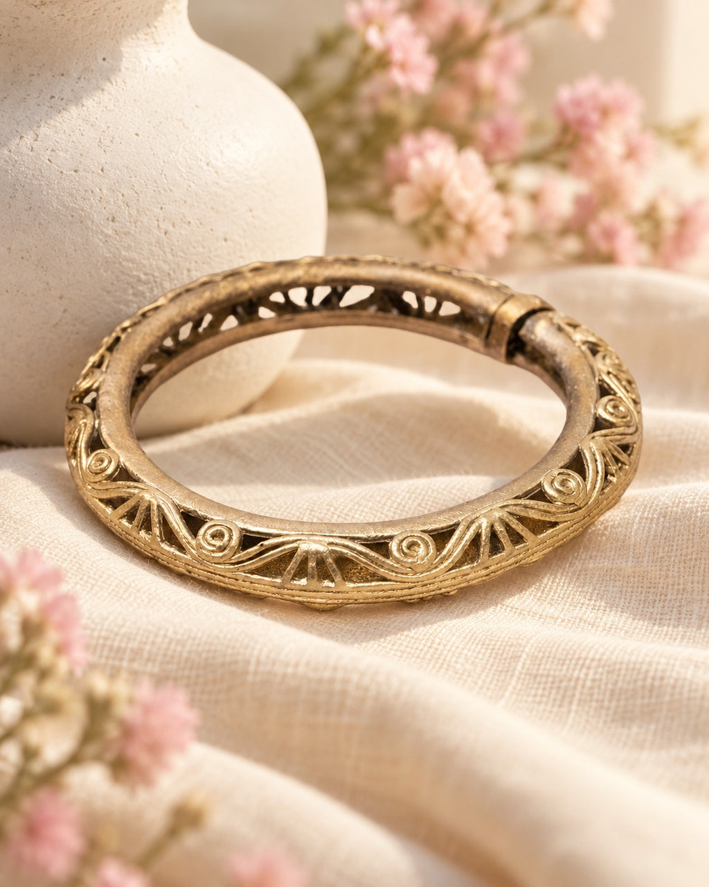 Styled image: Sona Bell Metal Floral Kada on linen