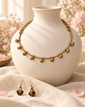 Styled image: Sona Bell Metal Ghungroo Necklace Set on a white vase