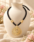 Styled image: Shyam Bell Metal Teardrop Pendant Necklace Set with Black Beads on a white vase