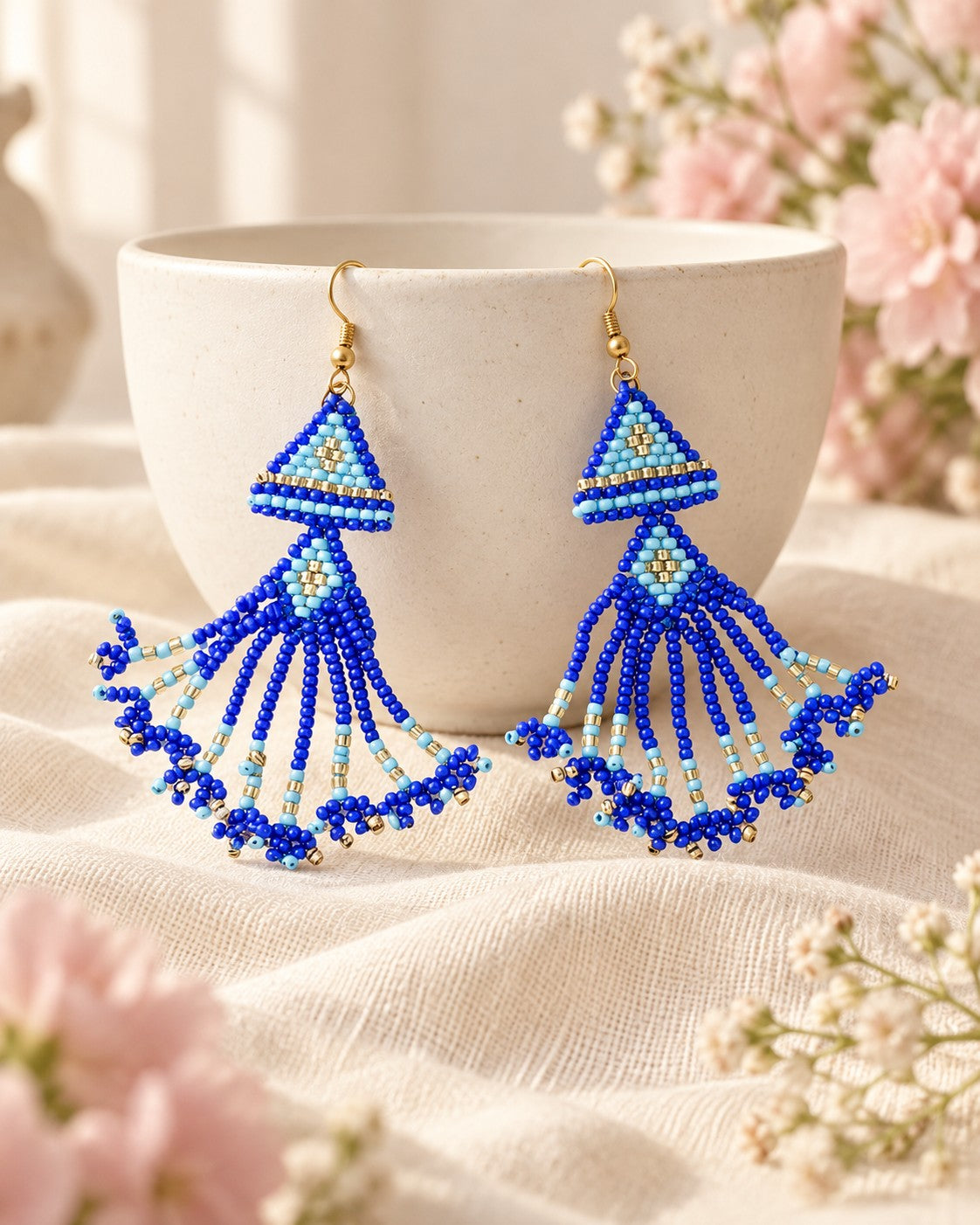 Styled image: Neel Geometric Beaded Earrings on a ceramic bowl