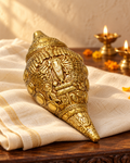 Styled image: Carved Brass Shankh on ivory handloom with Diwali diyas